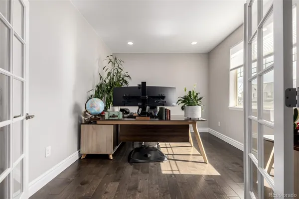 a work room with furniture and a flat screen tv