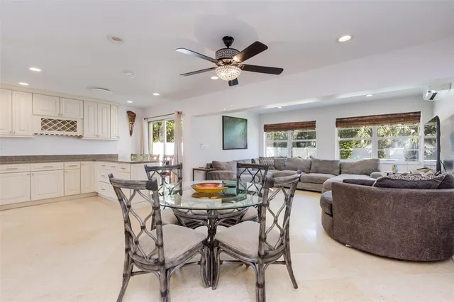 a living room with furniture and a dining table with kitchen view
