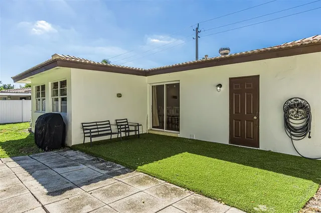 a view of a swimming pool with a yard and trees