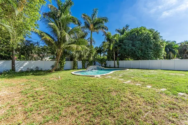 a view of swimming pool with a garden and trees