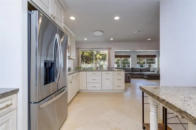 a kitchen with stainless steel appliances granite countertop a refrigerator stove and microwave