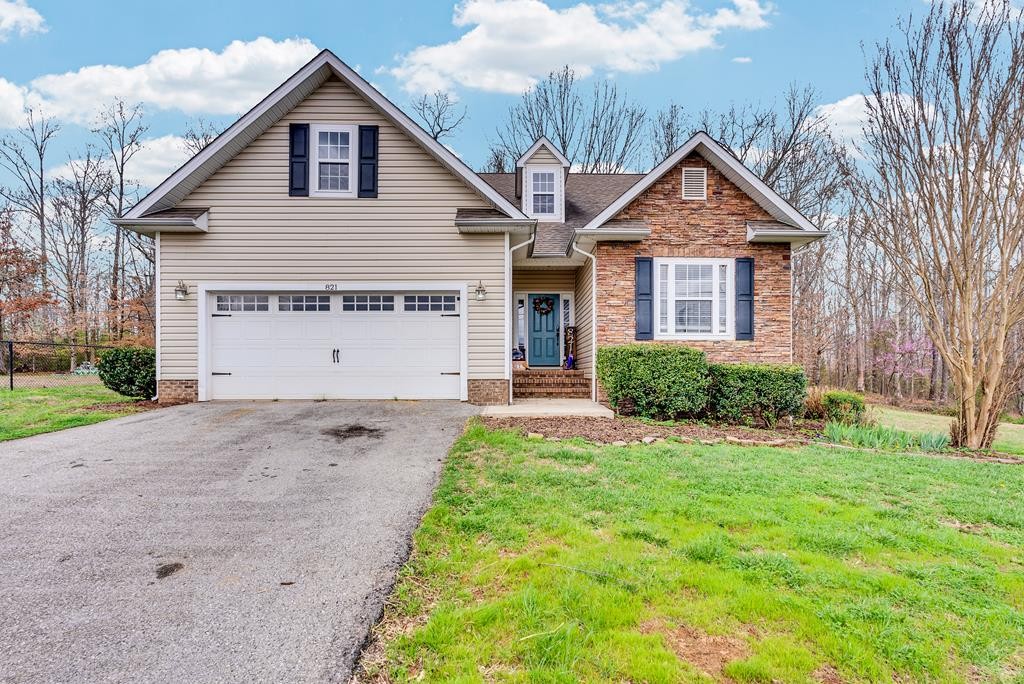 821 Honeysuckle Lane Sparta, TN 38583 - Photo 1 of 25 a front view of a house with a yard and garage