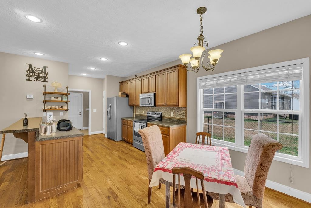821 Honeysuckle Lane Sparta, TN 38583 - Photo 13 of 25 a view of a dining room with furniture window and wooden floor