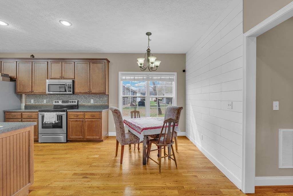 821 Honeysuckle Lane Sparta, TN 38583 - Photo 14 of 25 a dining room with furniture window and wooden floor