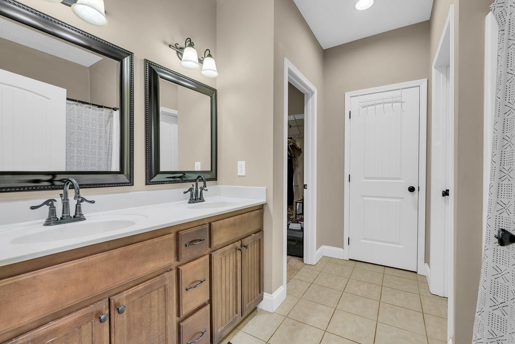 821 Honeysuckle Lane Sparta, TN 38583 - Photo 15 of 25 a bathroom with a double vanity sink and a mirror