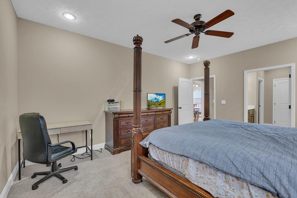 821 Honeysuckle Lane Sparta, TN 38583 - Photo 16 of 25 a bedroom with a bed a desk and chair