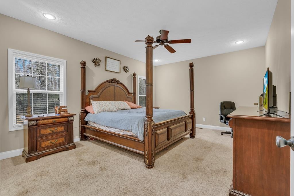 821 Honeysuckle Lane Sparta, TN 38583 - Photo 17 of 25 a bedroom with a bed next to a window with a chandelier