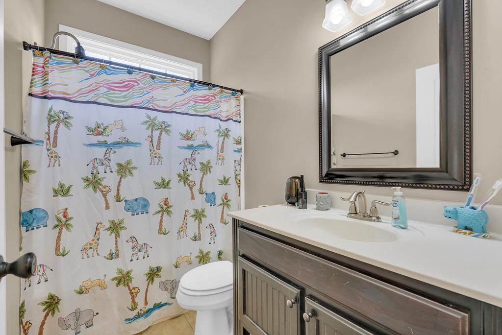 821 Honeysuckle Lane Sparta, TN 38583 - Photo 19 of 25 a bathroom with a sink a toilet and a mirror
