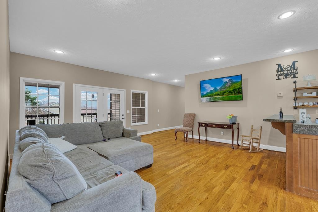 821 Honeysuckle Lane Sparta, TN 38583 - Photo 7 of 25 a living room with furniture a large window and wooden floor