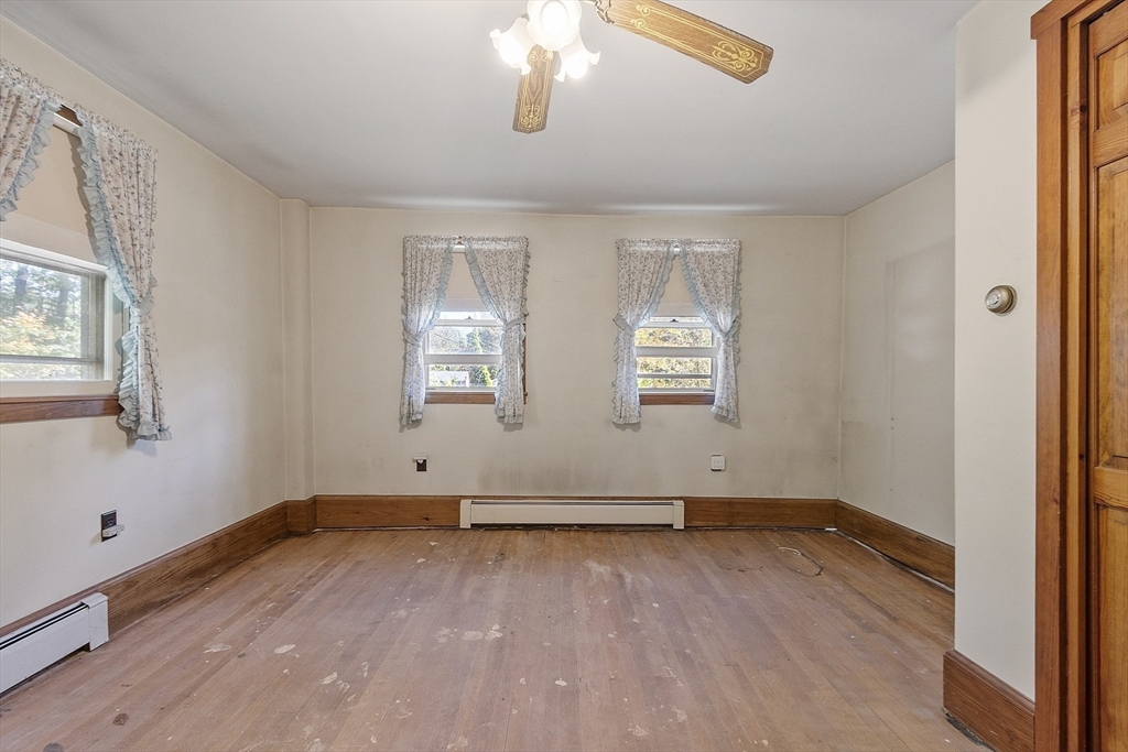705 Richardson Road Ashby, MA 01431 - Photo 15 of 42 an empty room with wooden floor and windows
