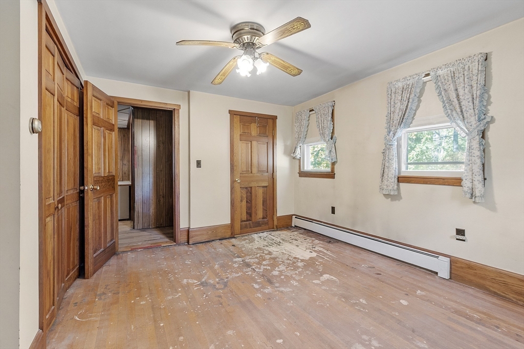 705 Richardson Road Ashby, MA 01431 - Photo 17 of 42 a view of a livingroom with a chandelier fan and windows