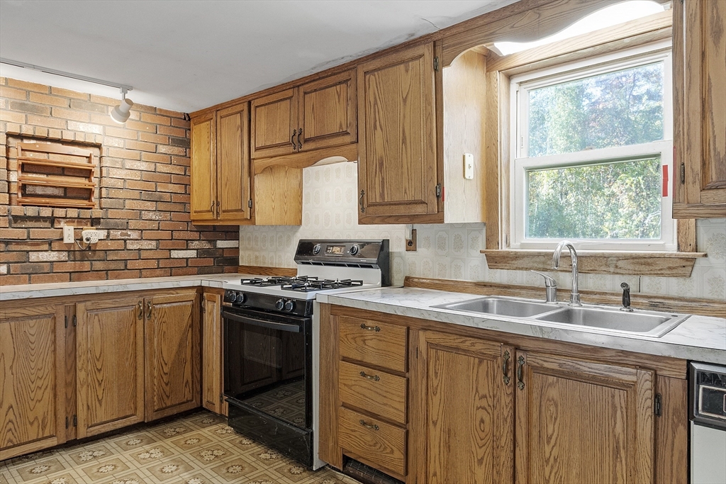 705 Richardson Road Ashby, MA 01431 - Photo 7 of 42 a kitchen with a sink stove and cabinets