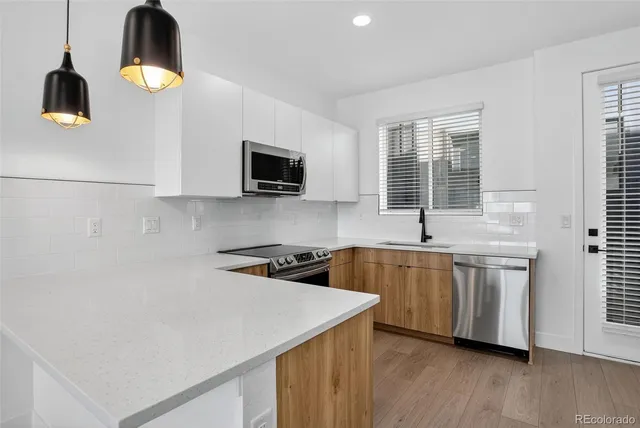 a kitchen with a refrigerator and a sink