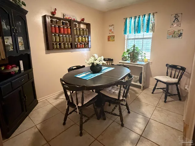 a view of a dining room with furniture and a potted plant