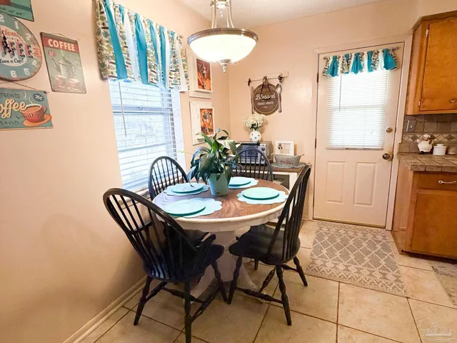 a dining room with furniture and window