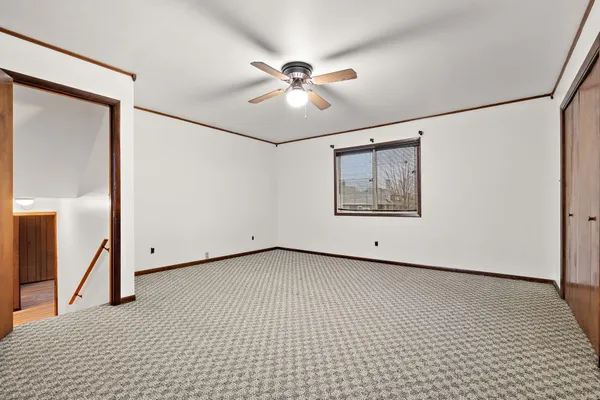 a view of an empty room with a ceiling fan