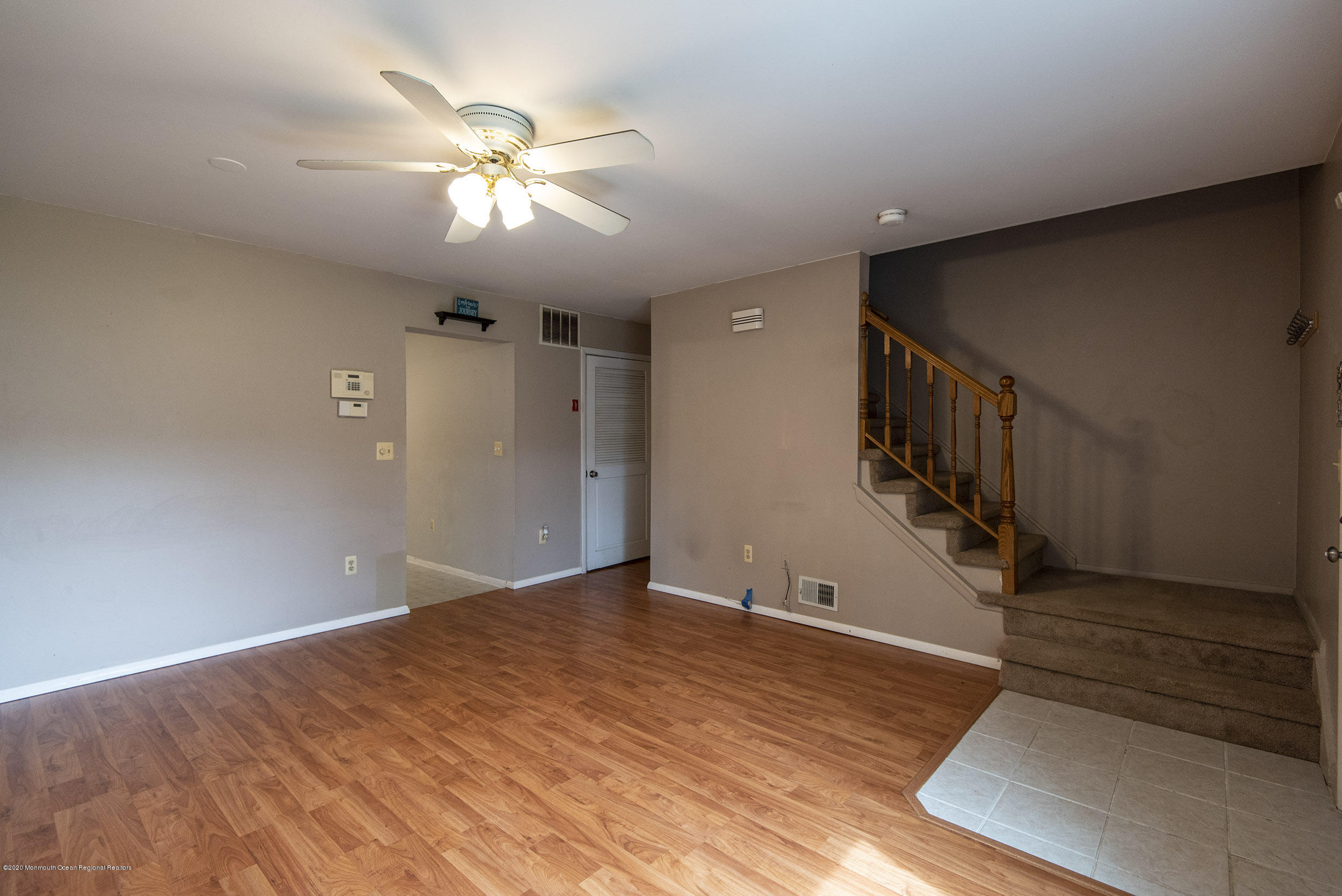902 Sandra Place Brick, NJ 08724 - Photo 8 of 28 a view of an empty room with wooden floor and a ceiling fan