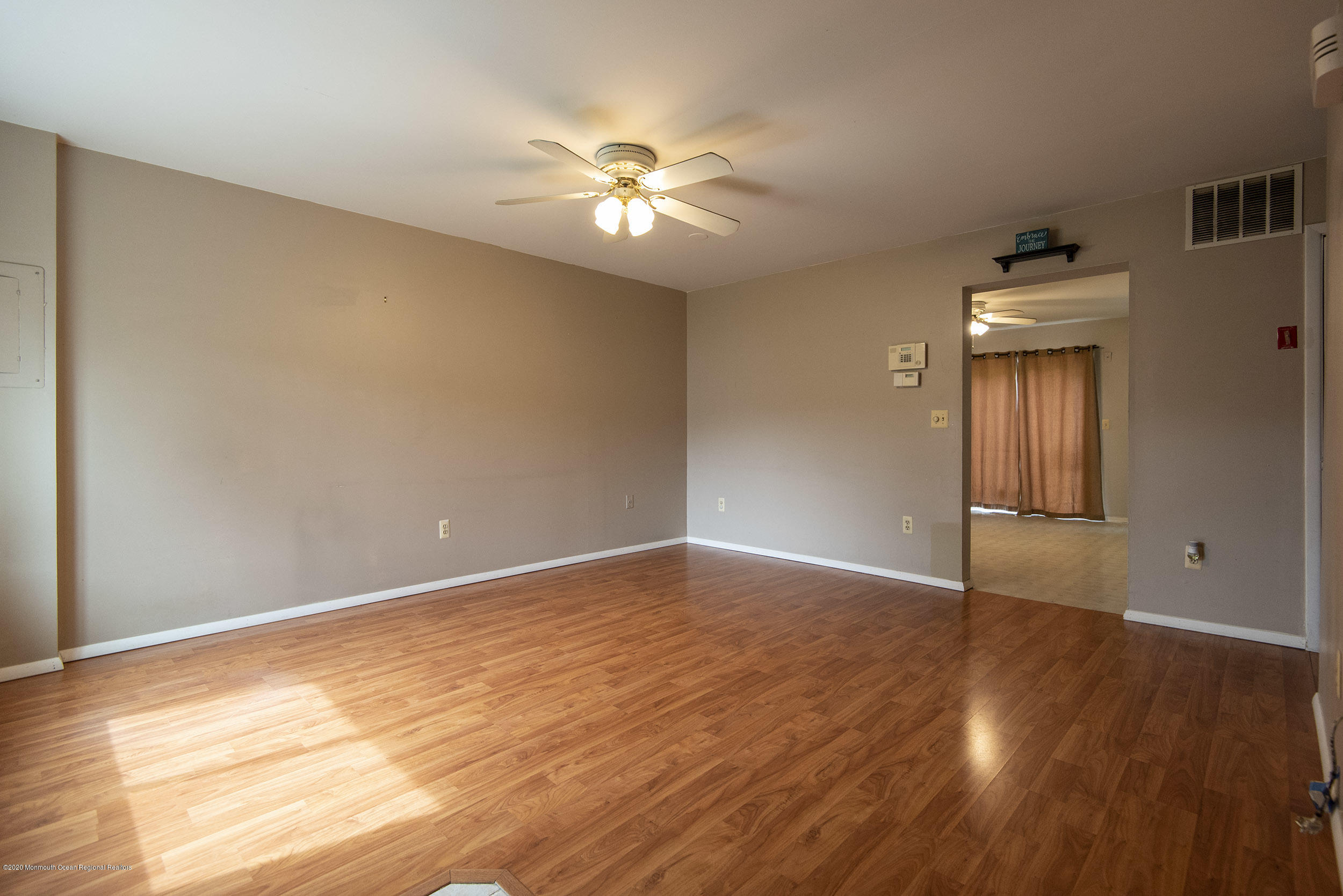 902 Sandra Place Brick, NJ 08724 - Photo 9 of 28 a view of an empty room with wooden floor and a window