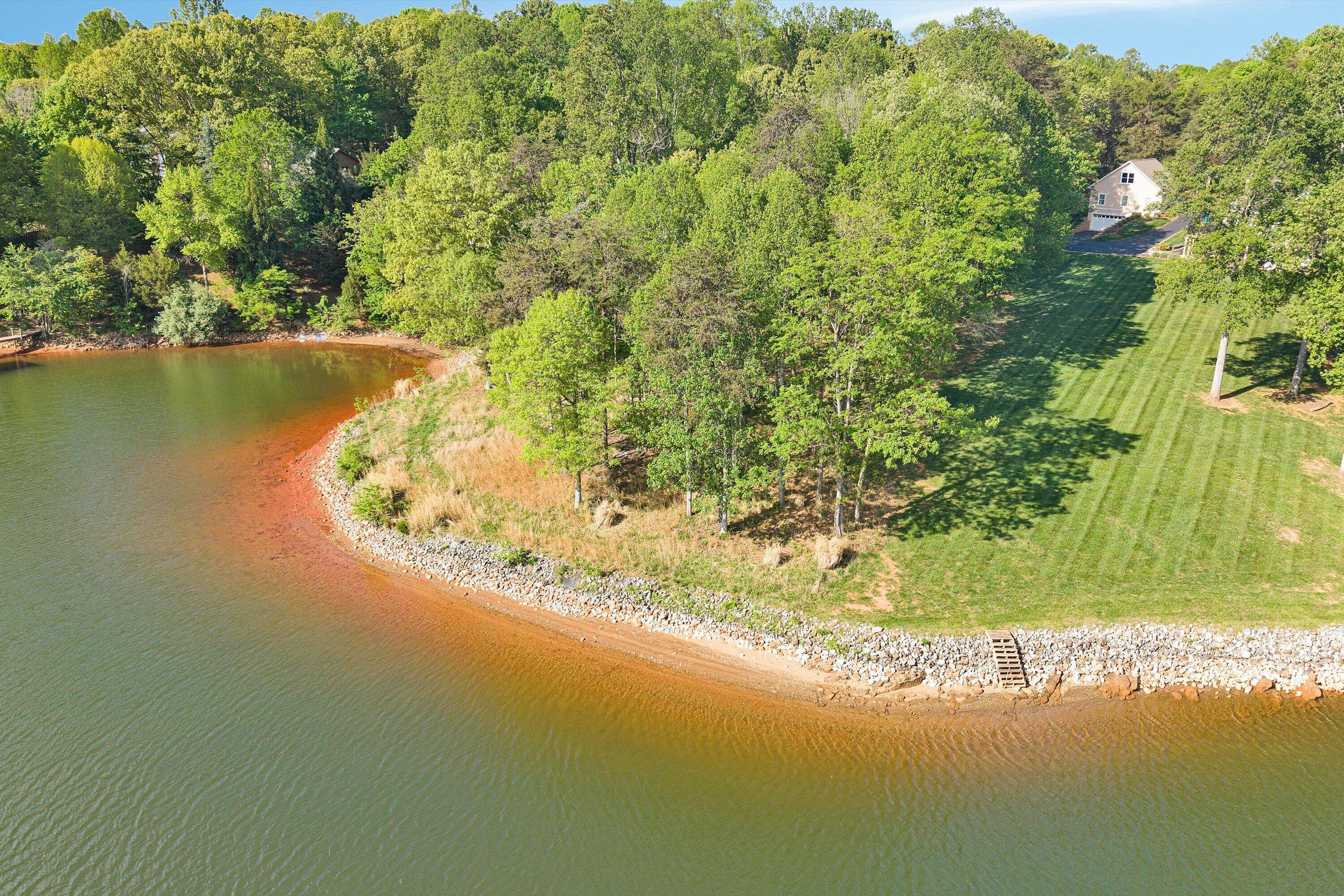Lot 4 Quarter Point Road Wirtz, VA 24184 - Photo 2 of 7 a view of a lake with a yard and large trees