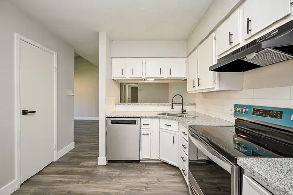 a kitchen with a sink stove and cabinets