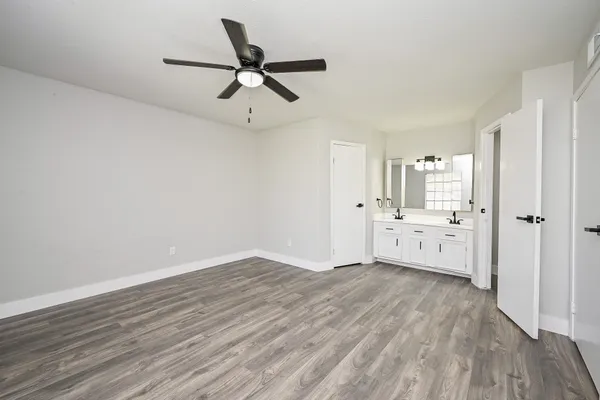 a view of a livingroom with a hardwood floor and a ceiling fan
