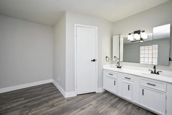 a spacious bathroom with a double vanity sink and mirror