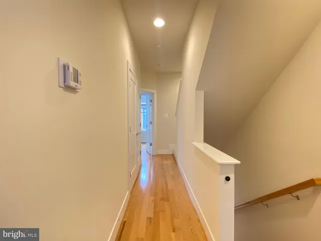 a view of a hallway with wooden floor