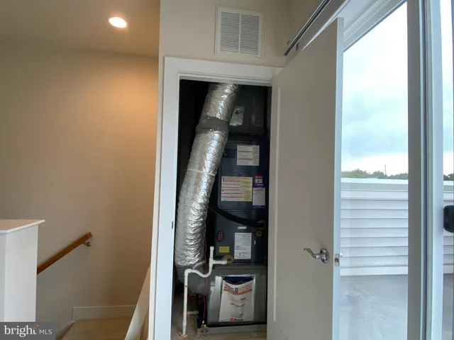 a view of hallway with washer and dryer next to a window