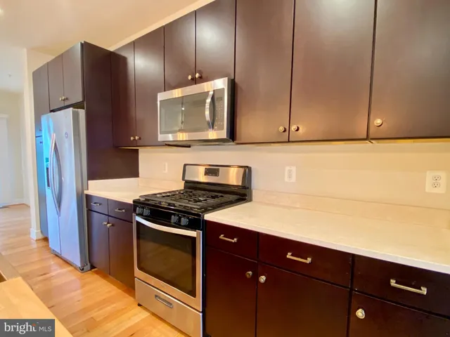 a kitchen with stainless steel appliances granite countertop a stove and a refrigerator