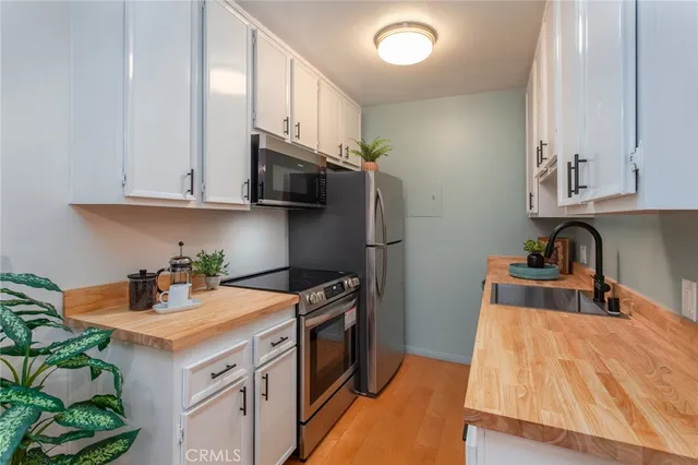 a kitchen with stainless steel appliances granite countertop a refrigerator stove a sink and dishwasher