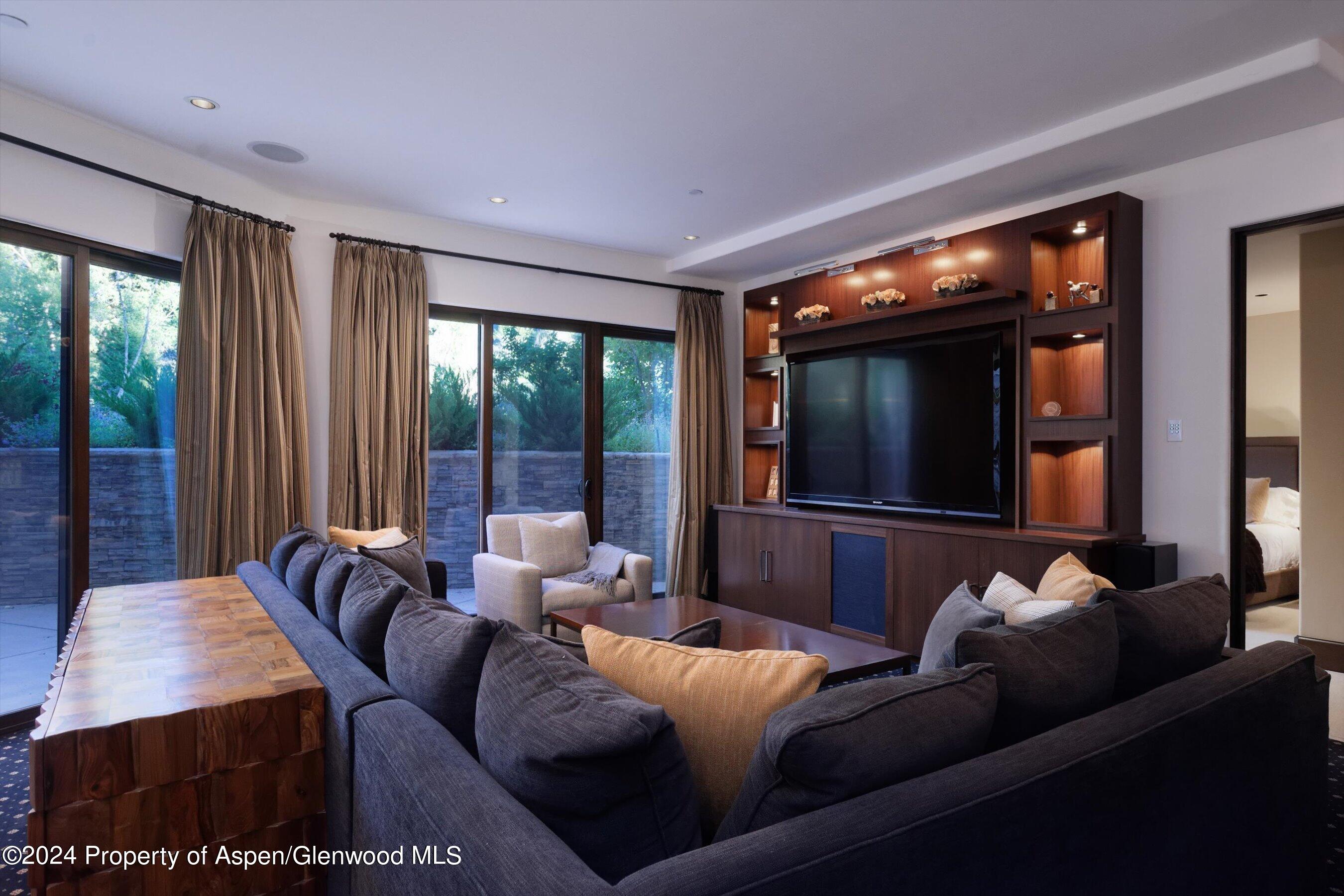 48 River Bend Road Snowmass, CO 81654 - Photo 18 of 32 a living room with furniture and large windows