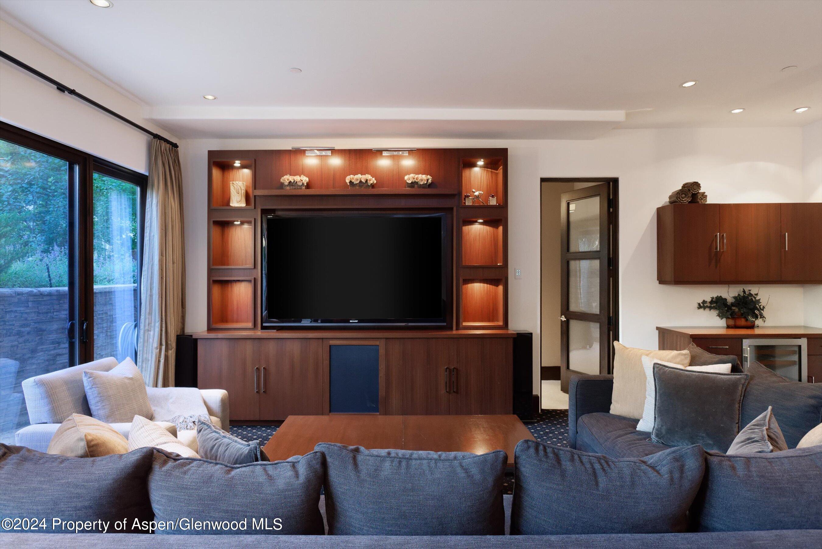 48 River Bend Road Snowmass, CO 81654 - Photo 19 of 32 a living room with furniture and a flat screen tv