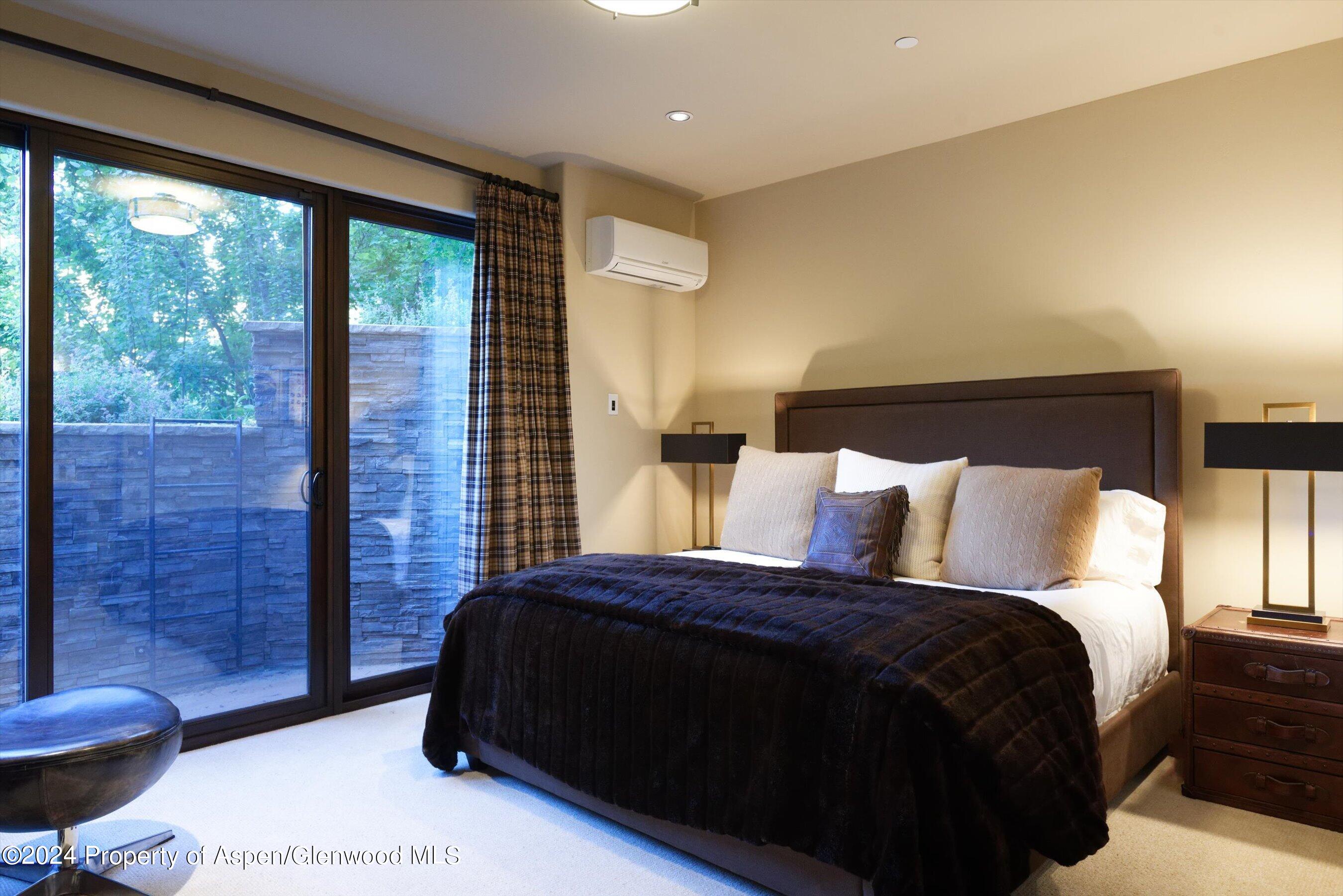 48 River Bend Road Snowmass, CO 81654 - Photo 20 of 32 a bedroom with a bed and a couch