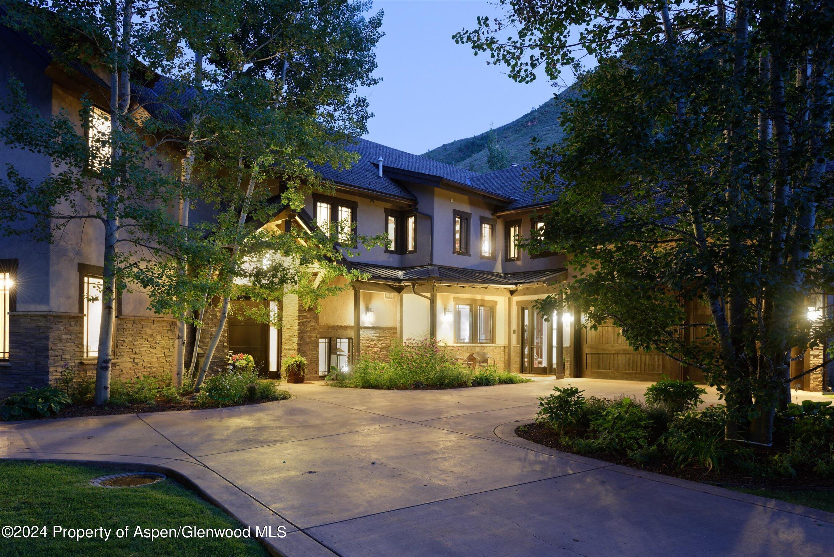 48 River Bend Road Snowmass, CO 81654 - Photo 2 of 32 a front view of a house with a yard and tree s