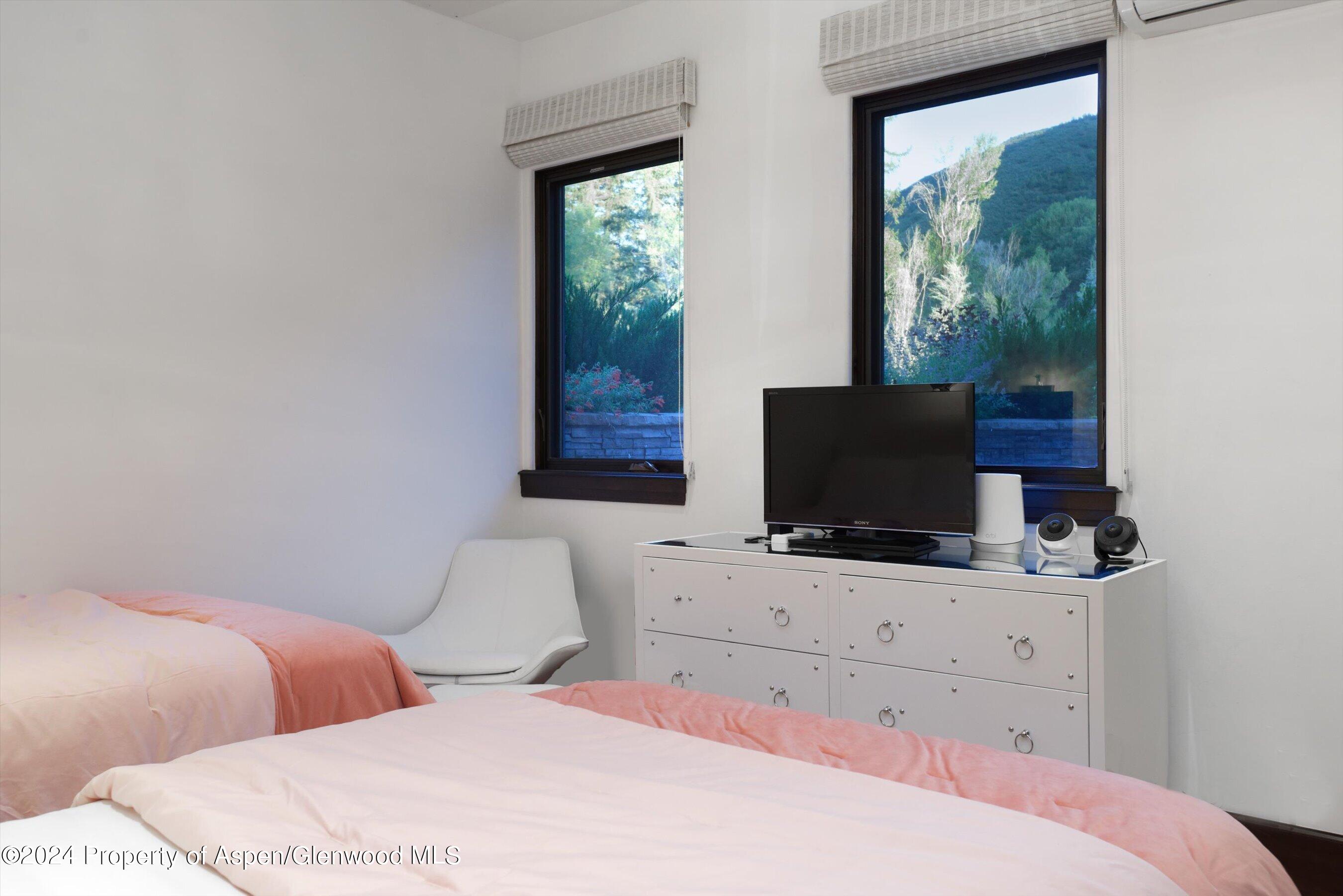 48 River Bend Road Snowmass, CO 81654 - Photo 22 of 32 a bedroom with a bed and a flat screen tv