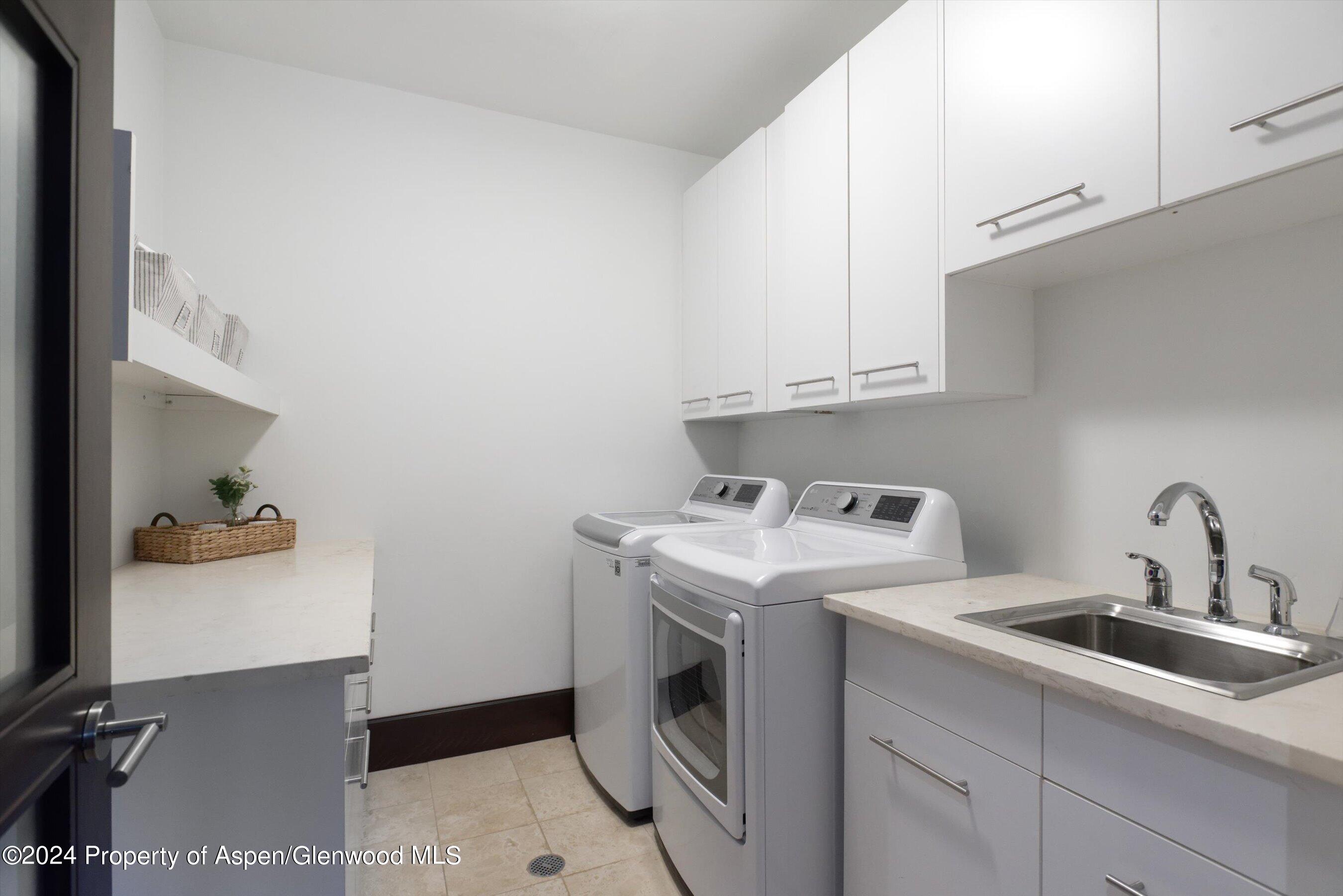 48 River Bend Road Snowmass, CO 81654 - Photo 24 of 32 a utility room with sink dryer and washer