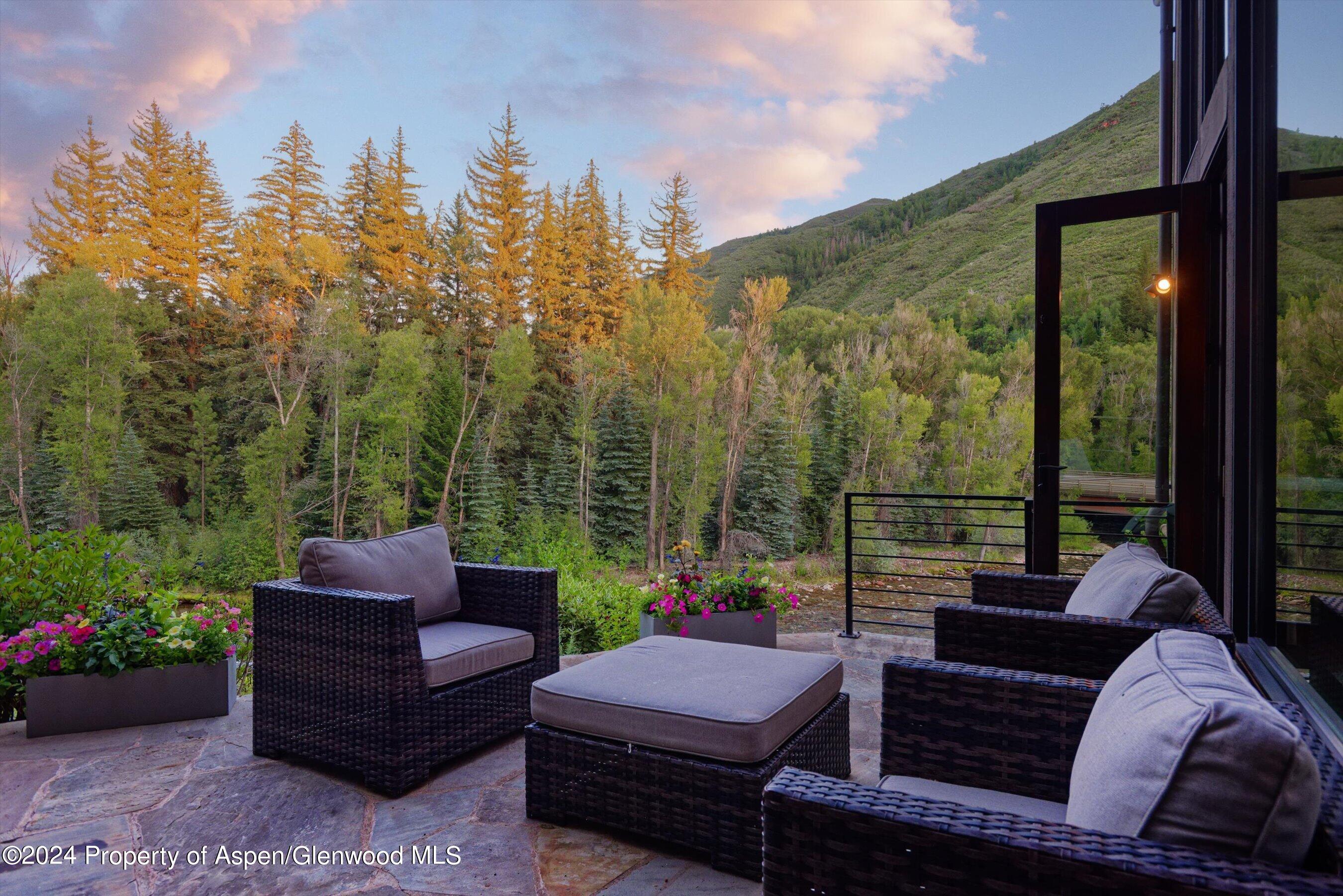 48 River Bend Road Snowmass, CO 81654 - Photo 27 of 32 a view of a patio with couches chairs and a potted plant