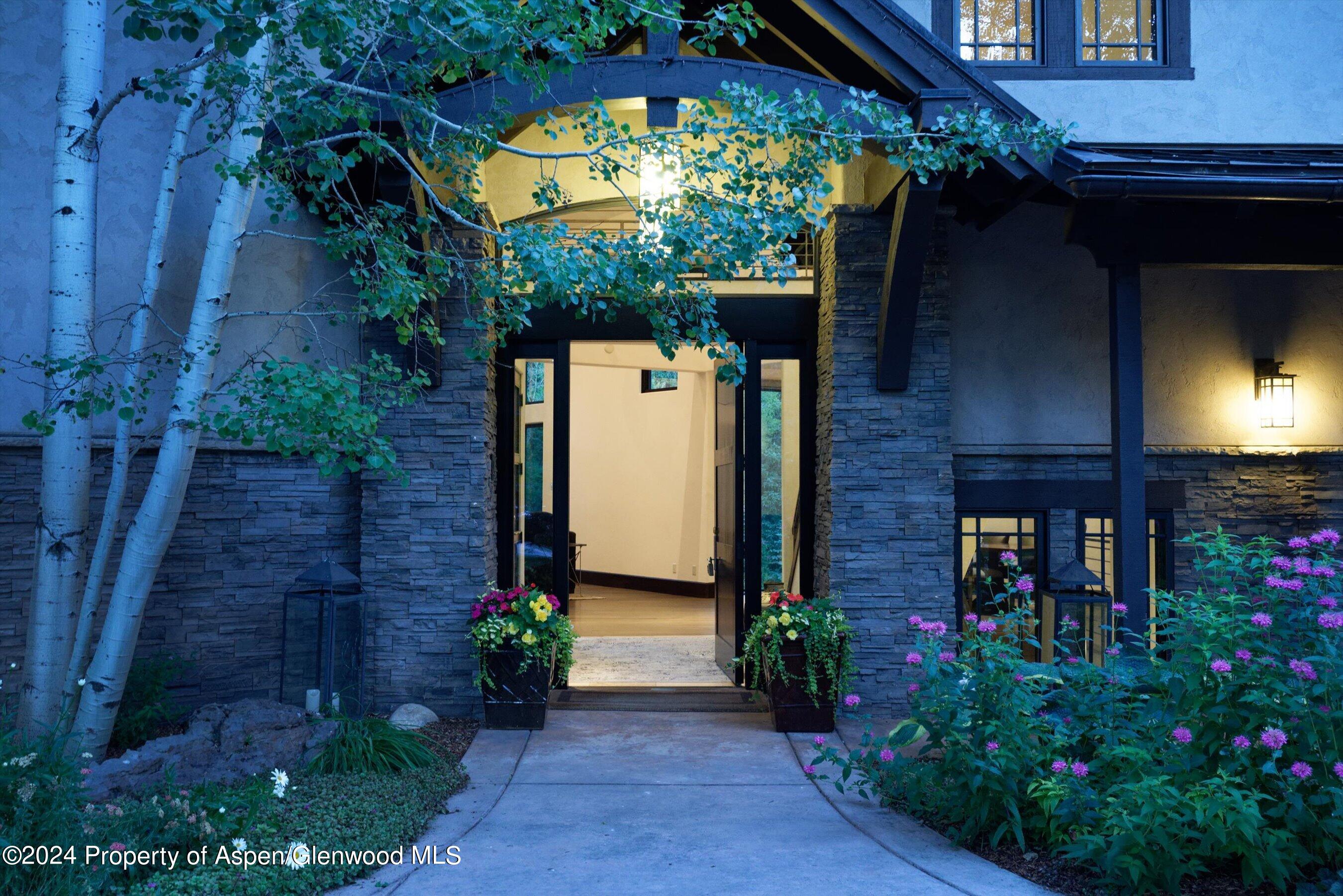 48 River Bend Road Snowmass, CO 81654 - Photo 4 of 32 a front view of a house with a garden