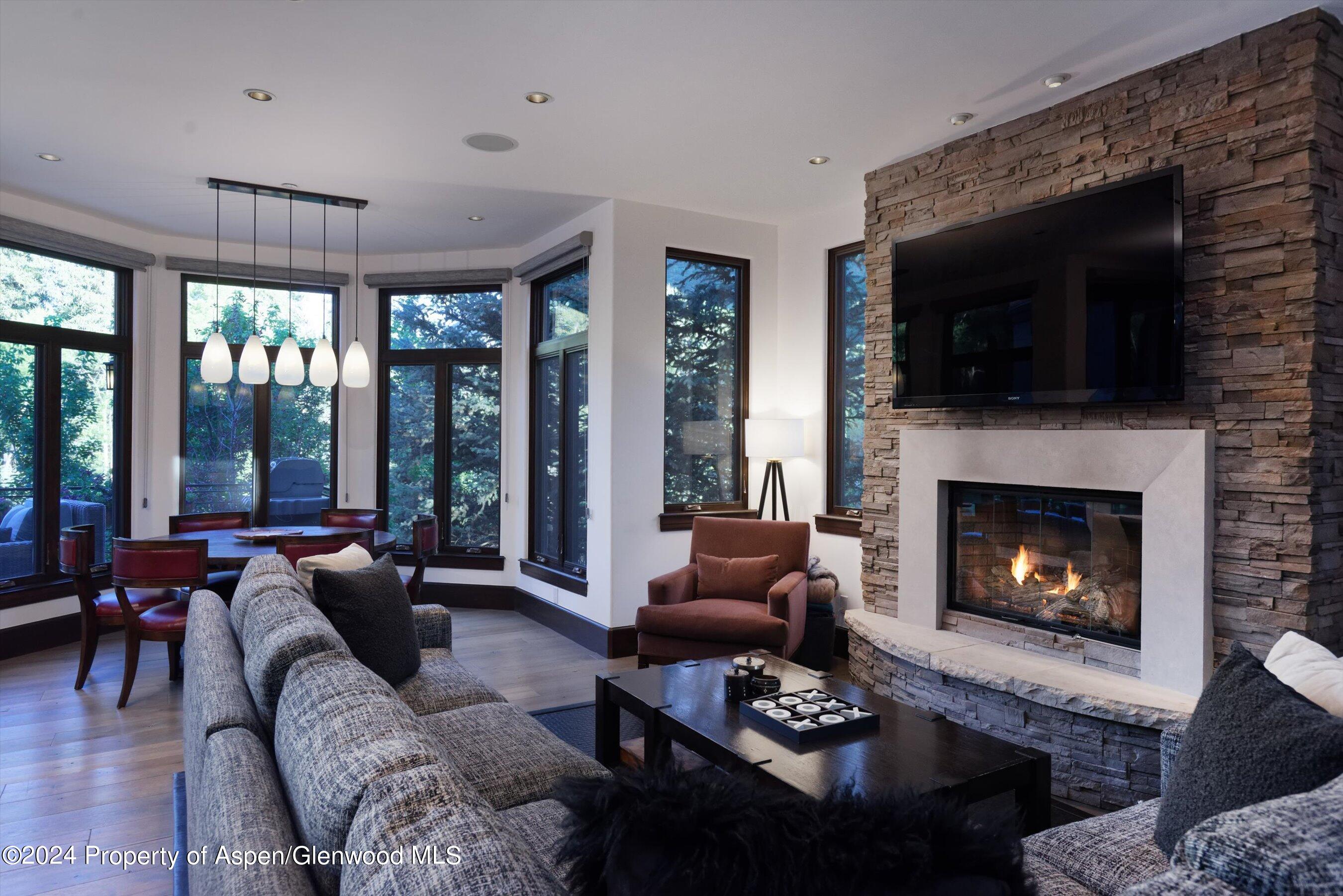 48 River Bend Road Snowmass, CO 81654 - Photo 9 of 32 a living room with furniture large window and a fireplace