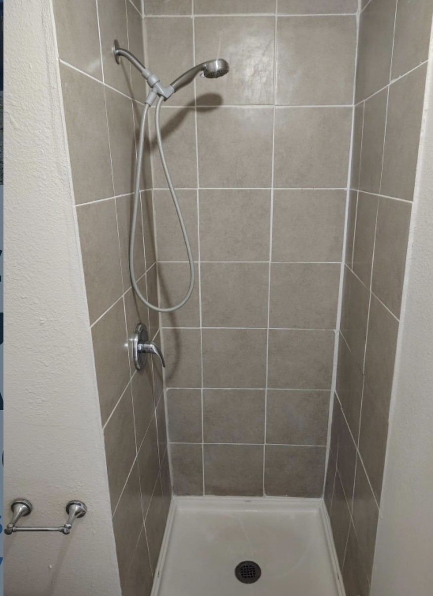 7509 Touchstone Street, Unit B Houston, TX 77028 - Photo 4 of 10 a bathroom with a shower and a tub