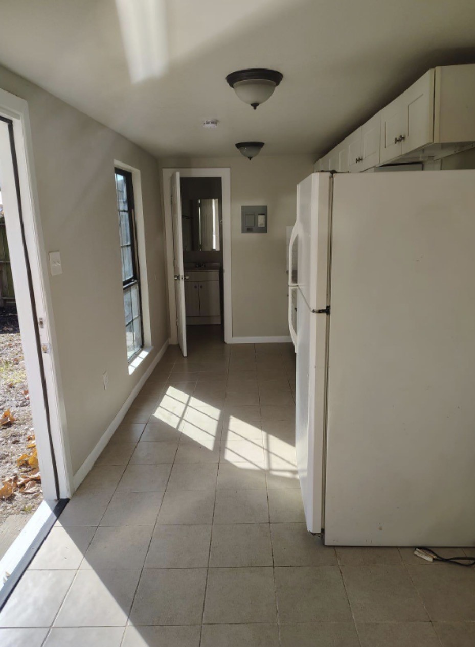 7509 Touchstone Street, Unit B Houston, TX 77028 - Photo 7 of 10 a view of a refrigerator in kitchen and livingroom with furniture