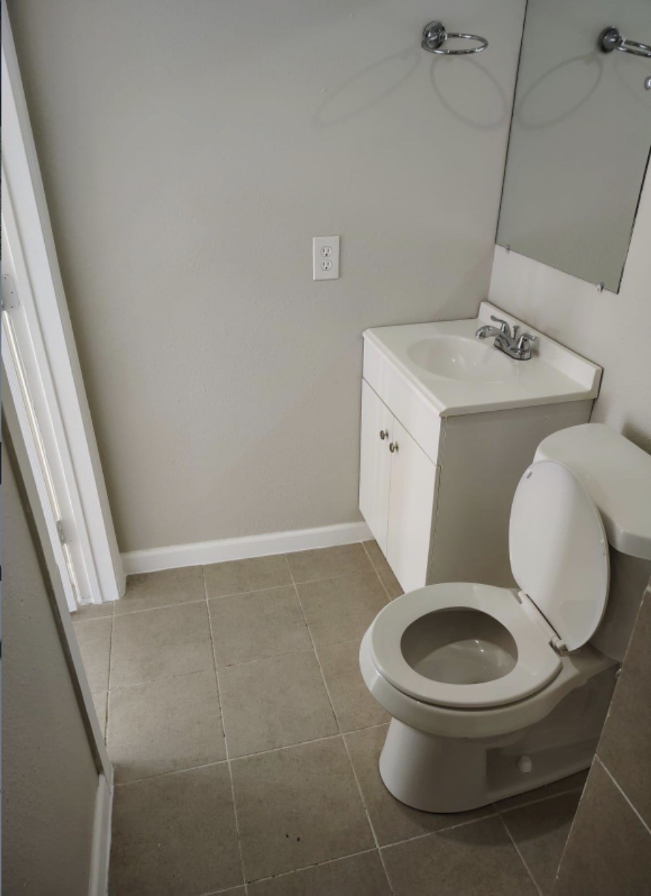 7509 Touchstone Street, Unit B Houston, TX 77028 - Photo 8 of 10 a white toilet sitting next to a bathroom sink