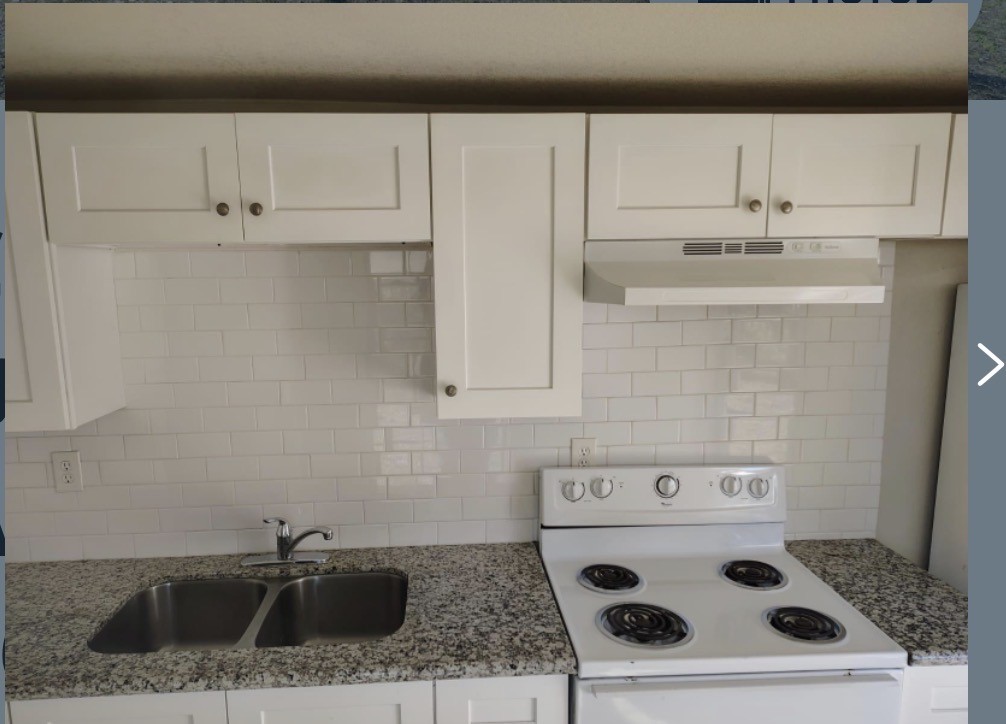 7509 Touchstone Street, Unit B Houston, TX 77028 - Photo 9 of 10 a kitchen with white cabinets and white appliances
