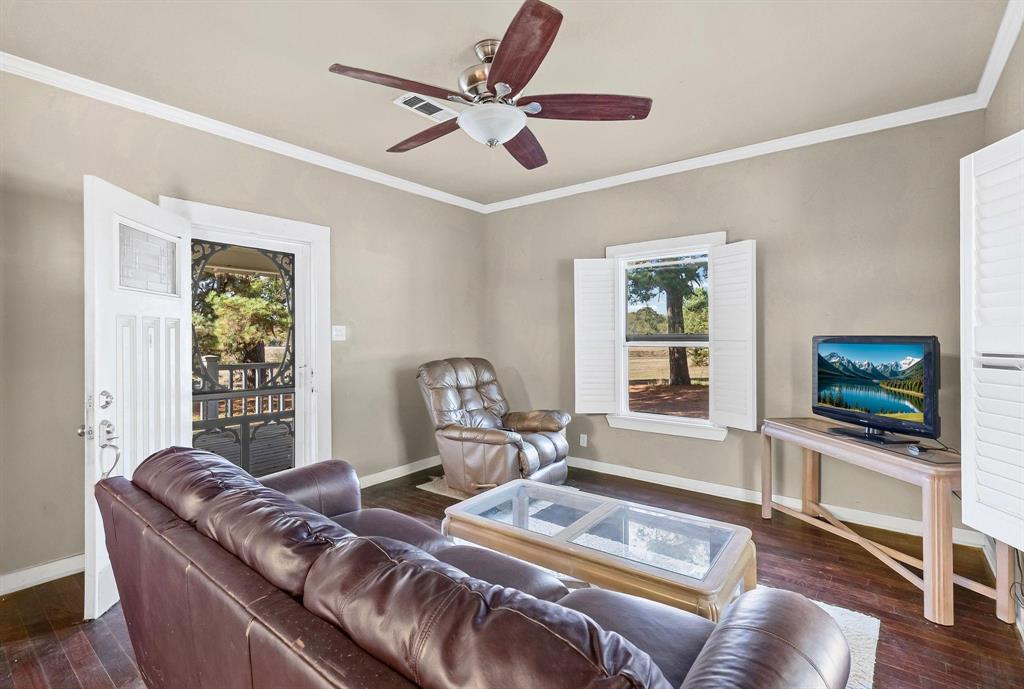 1207 Highway 24, Unit 2 Campbell, TX 75422 - Photo 26 of 35 a living room with furniture a flat screen tv and a large window