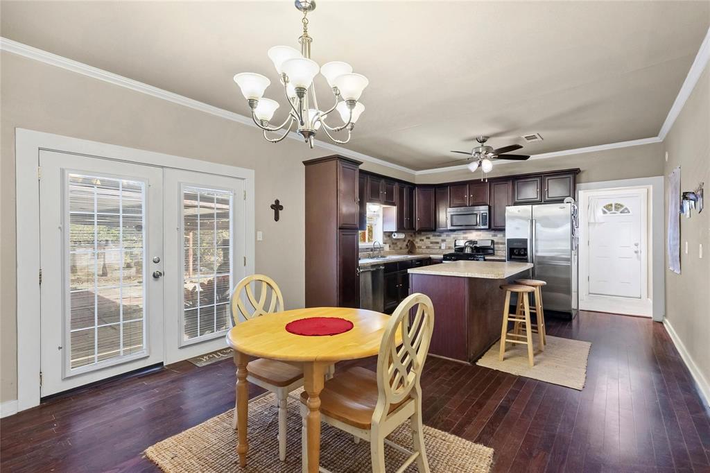 1207 Highway 24, Unit 2 Campbell, TX 75422 - Photo 29 of 35 a view of a dining room with furniture a chandelier and wooden floor