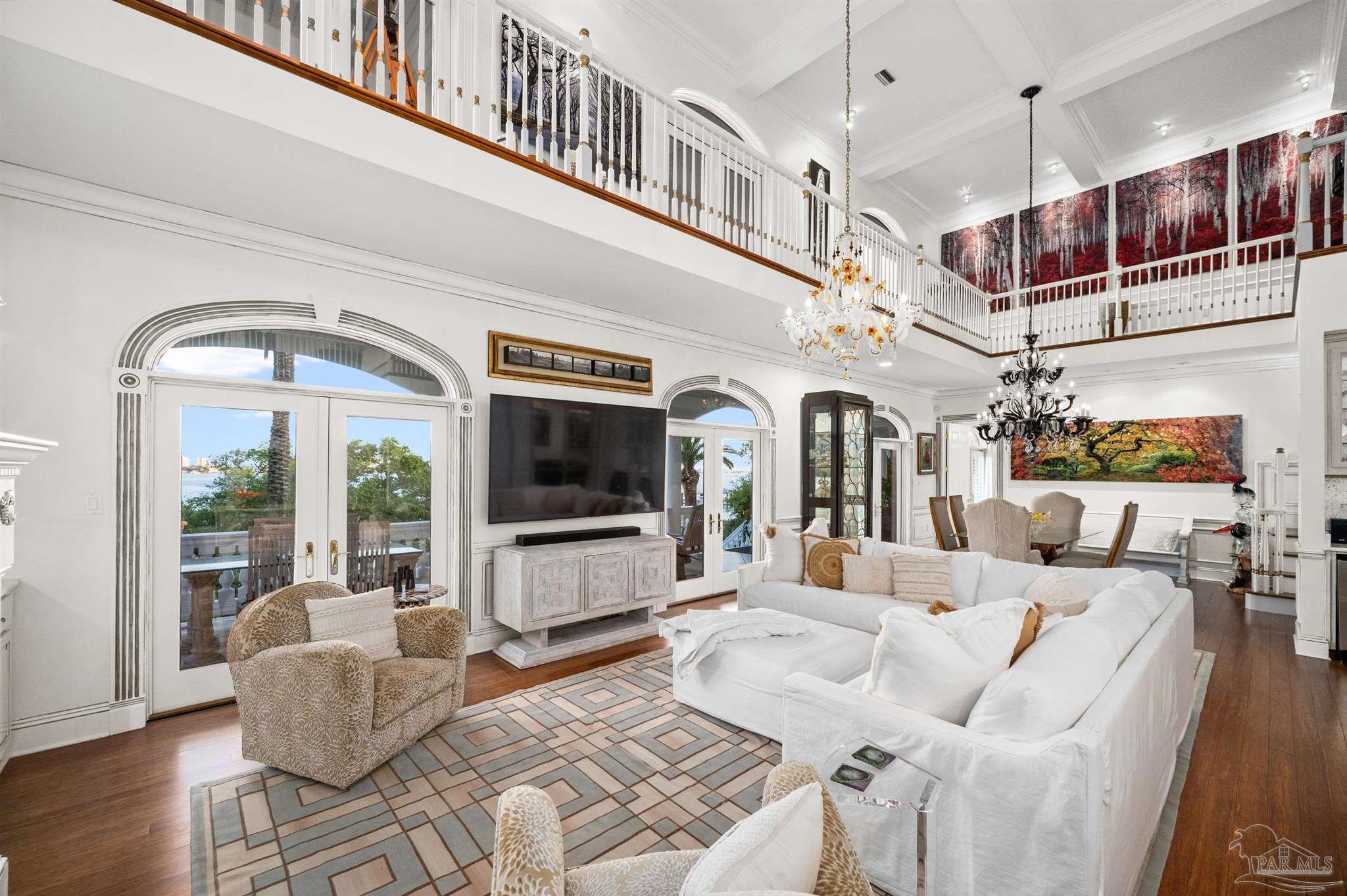 29416 Canal Road Orange Beach, AL 36561 - Photo 11 of 50 a living room with furniture a flat screen tv and floor to ceiling window