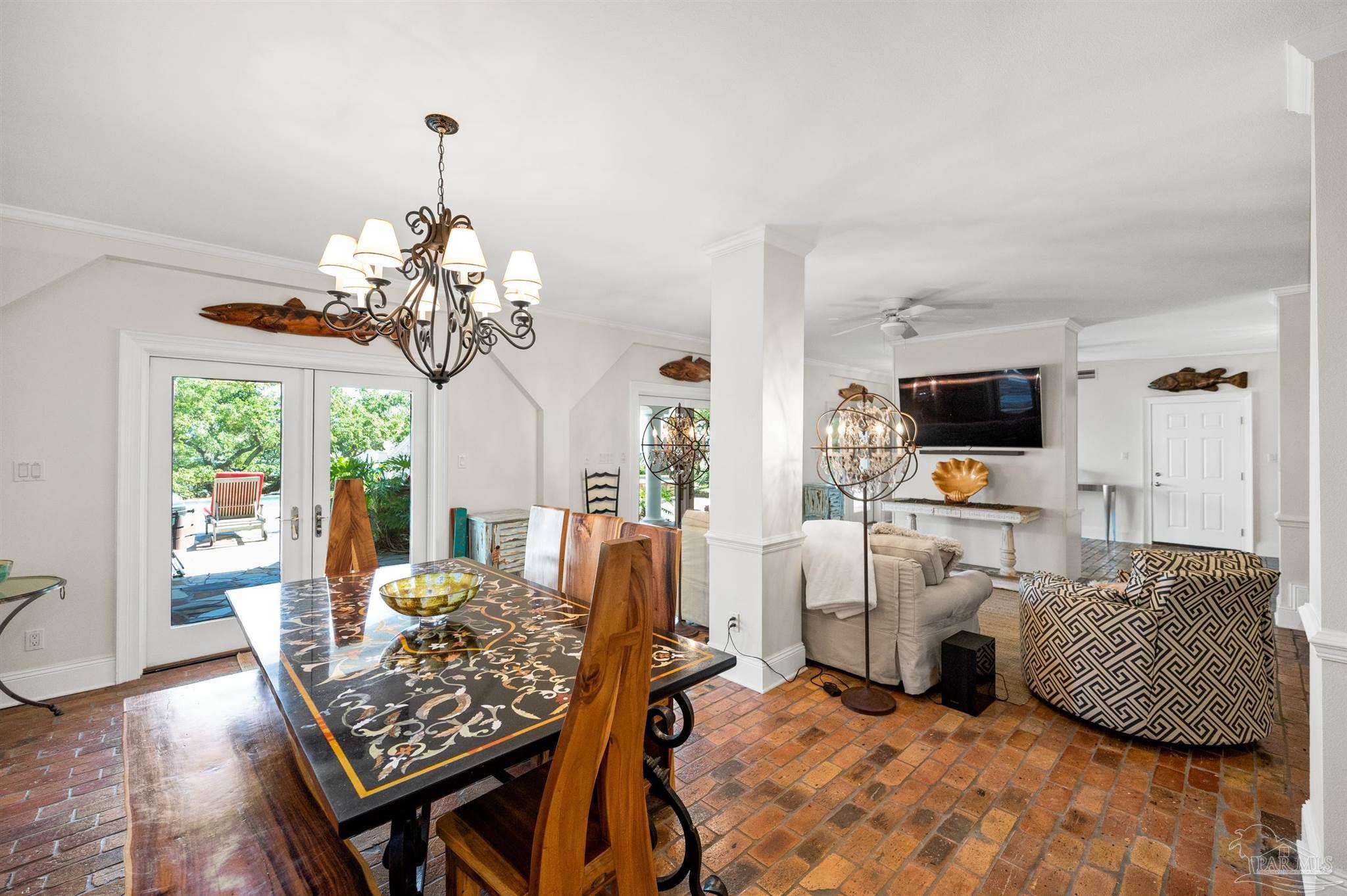 29416 Canal Road Orange Beach, AL 36561 - Photo 29 of 50 a view of a dining room with furniture a chandelier and wooden floor