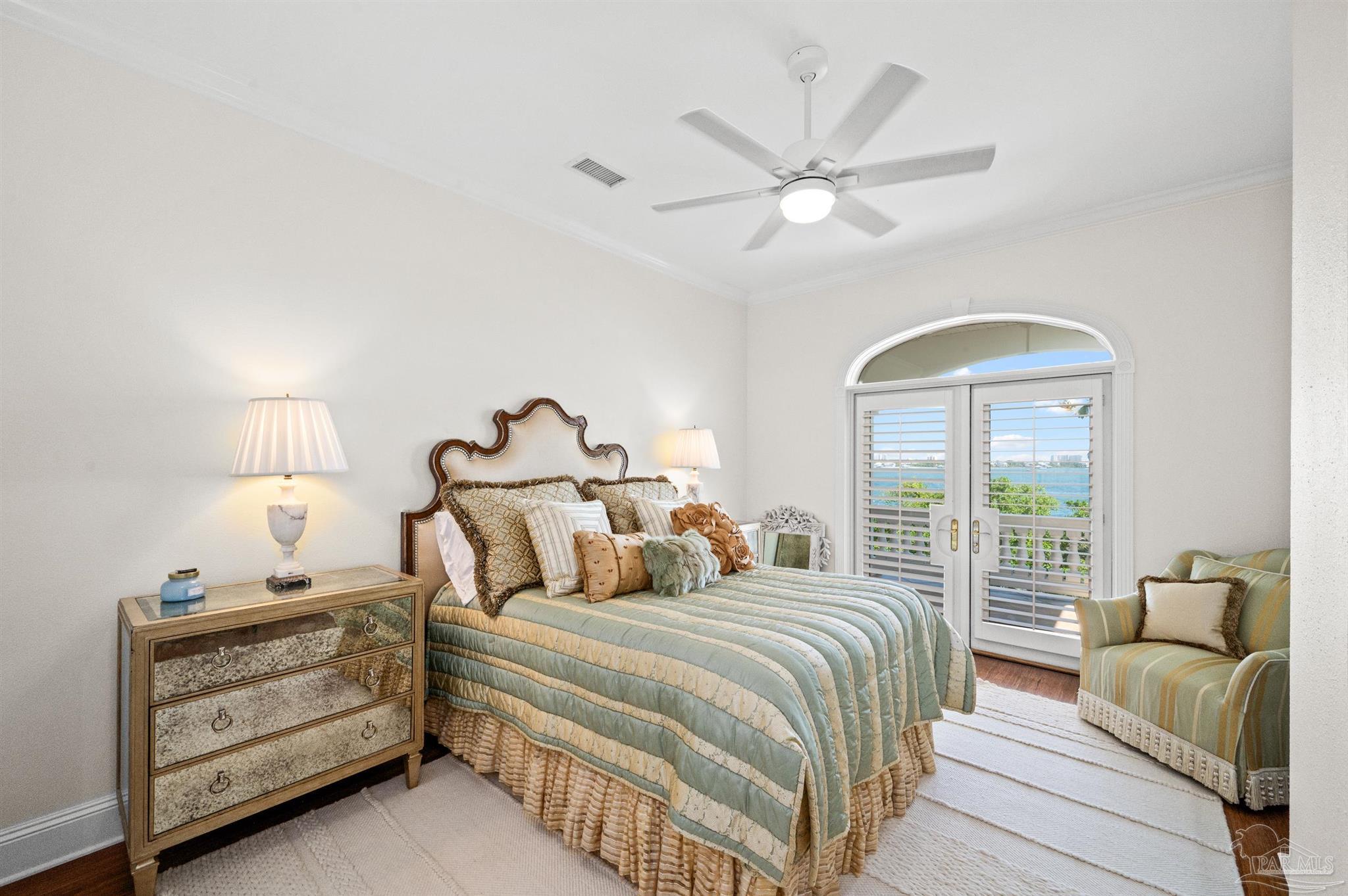 29416 Canal Road Orange Beach, AL 36561 - Photo 32 of 50 a bedroom with a bed and a chandelier
