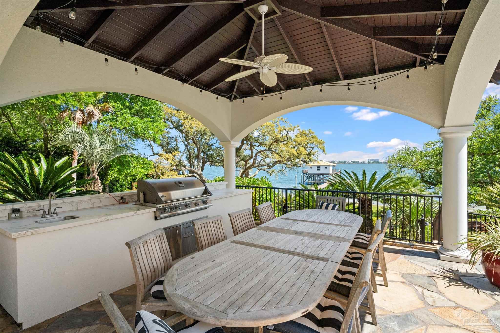 29416 Canal Road Orange Beach, AL 36561 - Photo 44 of 50 a view of a patio with table and chairs with wooden floor