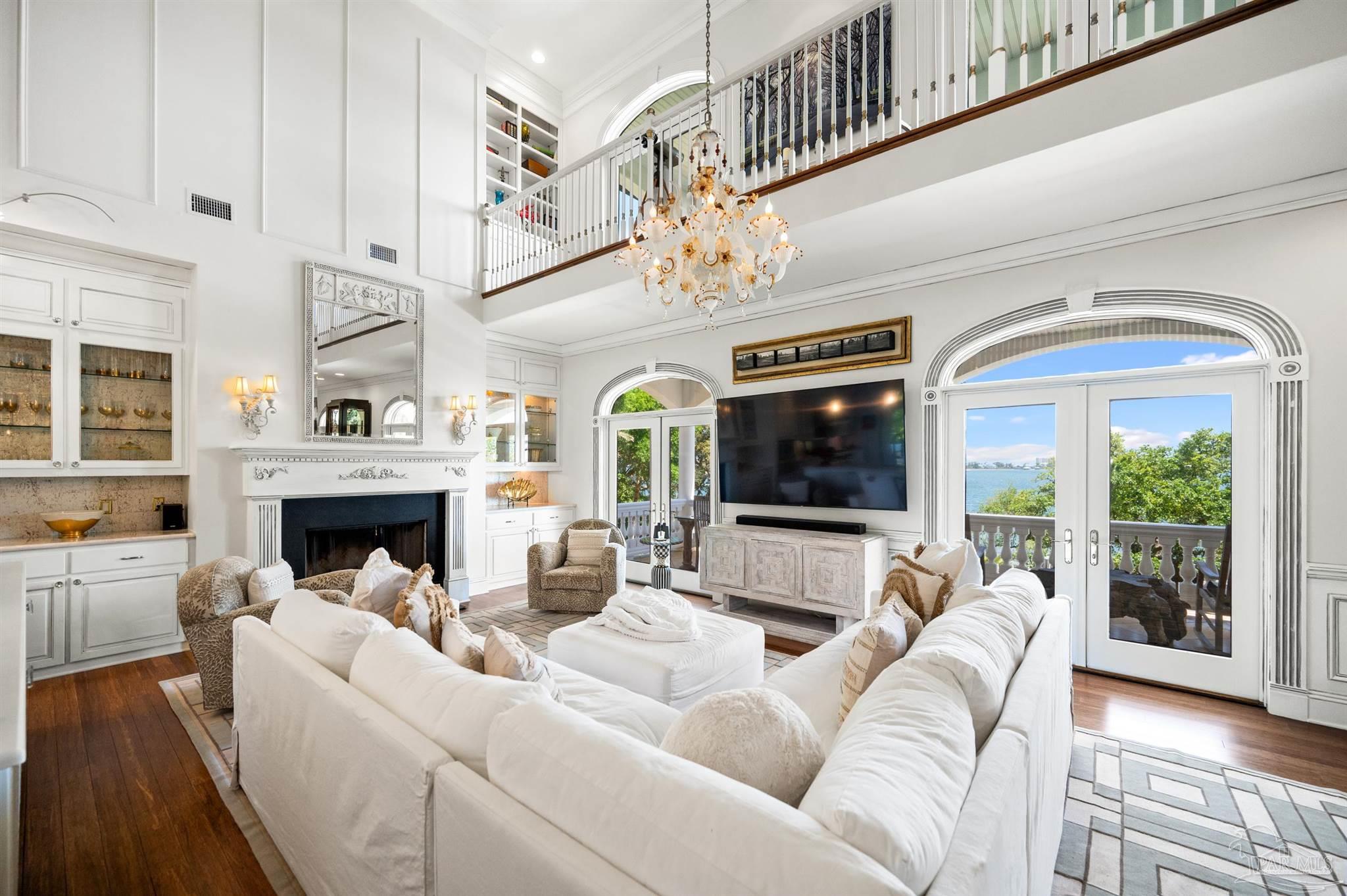 29416 Canal Road Orange Beach, AL 36561 - Photo 10 of 50 a living room with furniture a flat screen tv and a fireplace